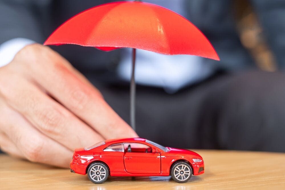 large-businessman-hand-holding-umbrella-cover-or-protect-KLS68TT